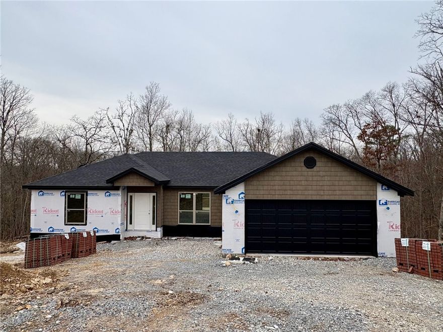 Live where adventure & comfort meet at 4 Dinton Lane in Bella Vista—the world’s mountain biking capital. Built in 2026, this thoughtfully designed home offers a split floor plan that makes daily life effortless, whether you’re hosting friends after a ride or enjoying a quiet night in. The open-concept layout showcases high-quality finishes, granite counters, a custom backsplash, & seamless flow for gathering. Retreat to the primary suite & unwind in the spa-like bath with a custom tile shower. Gutters & custom blinds are already in place for easy move-in. Set on a .40-acre lot with sewer, there’s room to breathe, entertain, or dream bigger. Minutes from the new bike park, groceries, & dining in NWA & MO—& with $5,000 in buyer incentives—this is more than a home; it’s a lifestyle. As part of the Bella Vista Property Owners Association, you’ll enjoy access to golf courses, swimming pools, recreation centers, fitness facilities, lakes, parks, & miles of trails—creating a community where every day feels like a getaway.