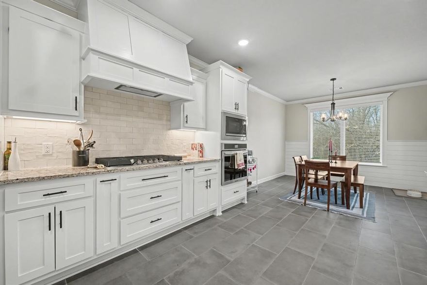 Lovely, well-maintained home in the desirable Arlington Subdivision, located in the Pea Ridge School District. This split floor plan offers comfort and privacy, accented by stained wood beams, crown molding, and a cozy gas fireplace with shiplap detail. The kitchen features granite countertops and opens seamlessly to the main living areas. The spacious primary suite includes a jetted tub and a tiled walk-in shower. With two full bathrooms and an additional half bath, there’s room for everyone. Enjoy outdoor living on the well-designed covered patio overlooking a fully fenced yard with a 20' x 20' raised bed garden—ideal for relaxing or entertaining.