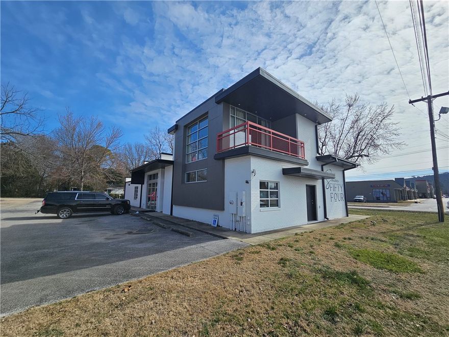 This former Fayetteville fire station has been converted into high end retail or office space.  Currently being used as an upscale salon with upstairs office. Great location just off of N College Avenue.  Corner lot of just over half an acre with plenty of parking.  2 bathrooms, one with a shower.  Kitchen space. Covered upstairs patio. New roof, hvac systems etc.