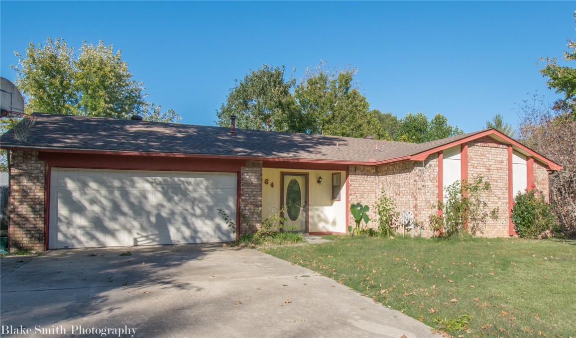 Charming 3 bed, 2 bath single family home in East Fayetteville! Just minutes from Mission Blvd, Whole Foods, and Razorback Greenway access, this 1,300 sqft home features a spacious living area with fireplace, galley-style kitchen, and classic wood cabinetry. Step outside to a large, fenced backyard with a brick-accented patio—perfect for relaxing or entertaining. Enjoy the convenience of an attached 2-car garage, central HVAC, and washer/dryer hookups. Located near schools, parks, and just a short drive to the U of A and downtown Fayetteville, this home offers peaceful living with quick access to everything NWA has to offer!