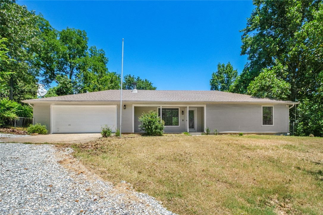 Beautiful Remodeled, Open Floorplan, Lake-Side Retreat less than a mile (.65 miles) from Hickory Creek Marina! Cozy Ranch Style home in an up & coming neighborhood on a Large Lot & priced to move quickly. Tons of yard space for your boat, RV, gardens, etc & healthy, mature trees for shade! All new & modern appliances, fresh paint, new floors, new A/C, new countertops, slab-on-grade layout; all perfect for low maintenance living. This is a great home to start anew, retire or raise your family, seconds from Beaver Lake on a quiet street with room to spread out. Wake up to easy access to #LakeLife! This doll house is move-in ready & waiting for you to start enjoying the best of NWA living! Looking to embrace lakeside life on a quiet street less than a mile from the lake w/o the waterfront price tag, maintenance or lack of privacy? Look no further #LAKELIFE! 1 yr warranty available with good offer. New appliances include: Refrigerator, Oven/cook-top, Washer, Dryer & Dishwasher! Open Houses hosted every Saturday 1-3pm.