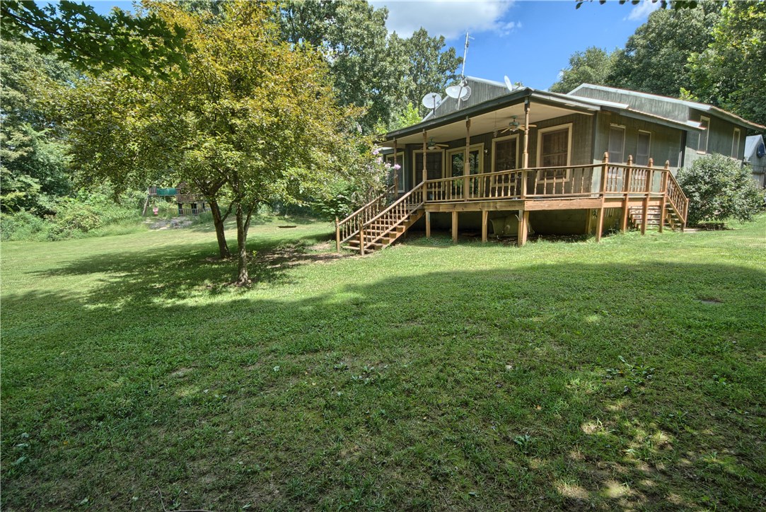 Well maintained home featuring a large kitchen with updated appliances, lots of cabinet space, a breakfast bar & separate dining room. Open concept living area with vaulted ceilings. Expansive basement with tons of possibilities for growing families, or entertainment ideas. Beautiful deck spanning the front and side of the home and sitting on almost 2 acres in a quiet private setting! Less than 10 miles to Bentonville and only a few miles to Gravette. Country feel but close to the action!