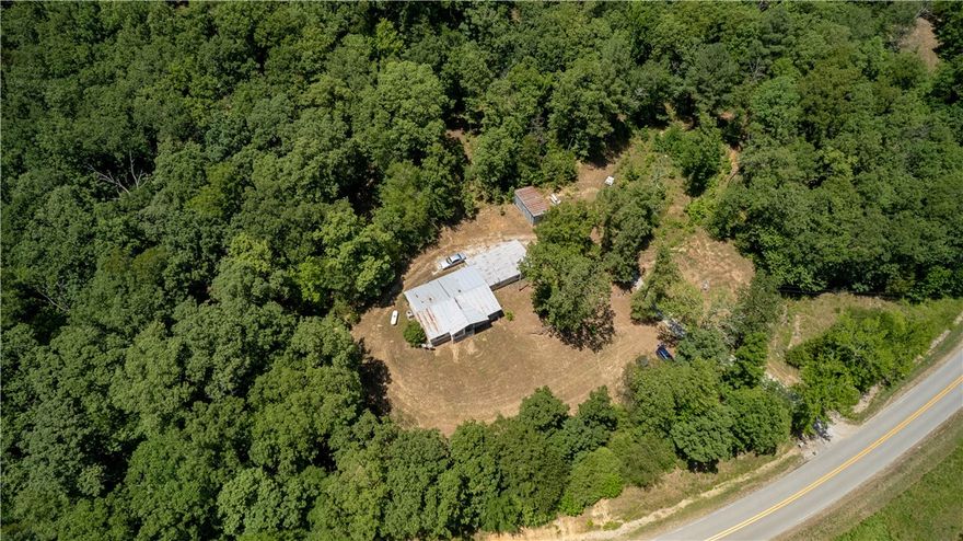 Enjoy outdoor recreation on stunning 40 acre getaway just 30 minutes from Fayetteville.  Acreage includes multiple building sites, with forest already cleared.  Short 30 minute drive to Byrds Adventure Center on the Mulberry River and one mile from the famous Pig Trail Bypass Country Cafe.