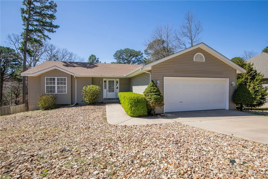 Awesome home in Bella Vista, Bentonville Schools. 3 bedroom 2 bath home, has split floor plan. Gas fire place and vaulted ceiling in living room. New wood style flooring throughout living room and bedrooms. Kitchen features pantry and refrigerator included. Great covered deck leading to a storage/work room below and Low maintenance yard.