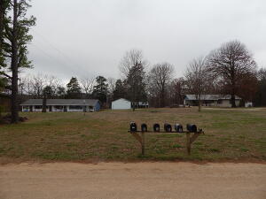 Great Investment Opportunity! Nice setting just outside of Berryville with views of hills, mix of wooded and open area, 3BR, 1BA home with attached carport, 1500 sq.ft. shop with 12x50 shed and plumbed for bathroom with separate room that could be living space with work, overhang, 24x40 pole shed, large fenced back yard, large dog house. 4 plex apartments all 1BR, 1BA, all setting on 4.11 acres m/l. Room to expand more apartment units behind current units.