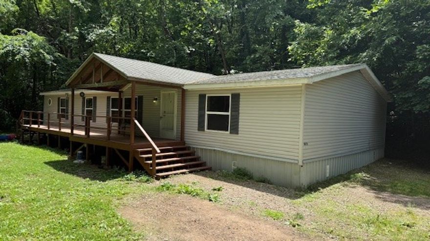 Beautiful, secluded property right outside of town! This property offers so many great features! Large mobile home with real hardwood floors and custom fireplace. A running creek year-round, perfect for hunting, a second clearing if you would like to build a dream home. 2 large garages that are fully operational for a mechanics shop with 3 bays plus lifts and air compressors (with acceptable offer). Don't miss the opportunity to own this peaceful retreat!