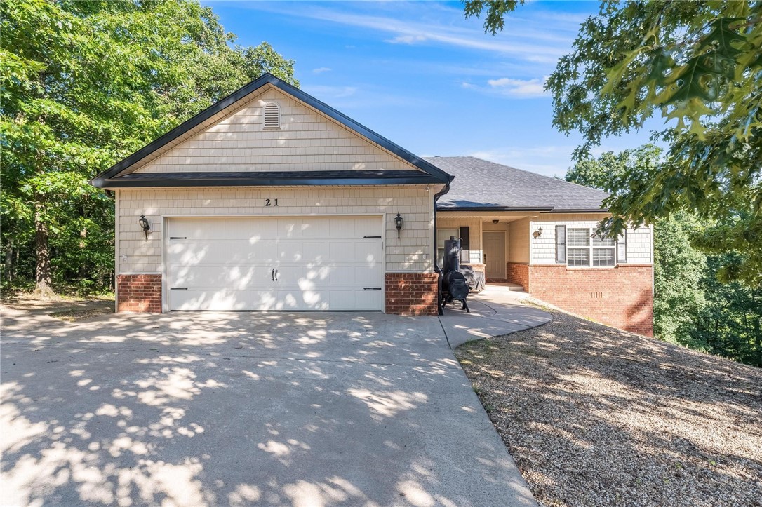 Discover the perfect balance of serenity and convenience in this gorgeous home, tucked away at the end of a peaceful cul-de-sac. Enjoy breathtaking views and a private, wooded backdrop that provide the ultimate escape. Ideally located just minutes from I-49, this home offers effortless connectivity to everything Northwest Arkansas has to offer. You're only 15 minutes from the vibrant culture and dining of Downtown Bentonville, with nearby access to world-class bike trails, scenic lakes, and pristine golf courses. Whether you're seeking adventure or relaxation, it's all within easy reach. Inside, the open floor plan welcomes you with light-filled living spaces designed for comfort and entertaining. Step outside to experience nature at your doorstep—where convenience meets quiet living.