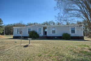 Anyone could really enjoy this almost 14 acre spread with excellent six stall barn, and doublewide mobile home sit up on a hill. The pasture is nice and level with a continuously feed pond with a stream. Fenced for cattle or horses, both are presently on the acreage. Mobile has had lots of updates and repair. 3 Bedroom or 4 with living room and den, kitchen and dining, and storm shelter, an lush Bermuda grass for livestock.