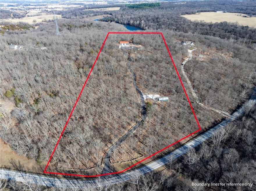 Exceptional secluded estate on 12.75 acres near Lincoln Lake, offering privacy and convenience. This custom home features 3 bedrooms and 3.5 bathrooms, with every bedroom having its own ensuite, and a spacious primary suite. The open floor plan showcases wood-look tile throughout, granite countertops, and a chef’s kitchen with GE Café appliances. Designed for peace of mind, the home includes a dual-fuel furnace, whole-house Generac generator, indoor 12-person storm shelter, and a pellet stove for added charm. Outside you’ll find a gated asphalt drive, smokehouse/meat smoker, 40x60 enclosed barn with open truss, and a 30x50 insulated shop with dual mini-splits and bathroom—ideal for business owners or equipment storage. A finished 16x40 cabin with bed, bath, kitchen, living space, and laundry offers options for guests, multi-gen living, or rental income. Whether you’re looking for a place to operate a business, host family, or enjoy quiet country living, this property delivers unmatched versatility and privacy.