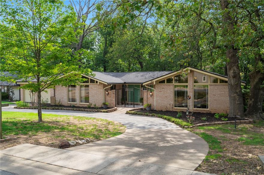 This stunning brick front home has been "home" to many who have gathered here over the last 20 years. It has so many spaces perfect for hosting. It has comfortably hosted 100+ for many gatherings. Located on coveted S. Dogwood St. it features a circle drive, 2 car garage and an amazing view of the forest & creek behind it. Feel one with nature while enjoying the shade from the screened in back porch perfect for relaxing, all while being right in the middle of town just steps from downtown & John Brown University via the Dogwood Springs Walking Trail. New paint, all new flooring in living, dining, hall, main bath and one of the bedrooms. Kitchen, and main bath recently updated/ remodeled. While the roof is only a few years old, but a brand new one is to be installed via recent insurance claim. There are several living areas/ and options to convert study or den into an additional bedroom if needed. HVAC was newly installed 2016. Kitchen remodeled 2019.