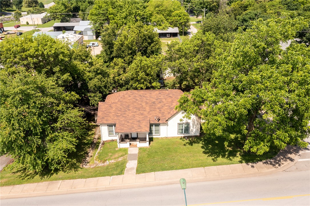 Historic Home 1 Block Off Historic Downtown Siloam Springs , (Request Attached Update List in Supplements), Huge City Lot .28 acres, 5 bedrooms, 2 Bathrooms, Detached Storage Building (182 sq. ft.), 3 Parking Spaces W. Benton Street, Detached Garage In Ally w/Parking, Nice Front Porch w/Swing, Privacy Fence Around Back Deck, Garden Plot / Playground, Large Living Room & Formal Dinning Room with Beautiful Original Bookshelf, Cellar Exterior Entrance, Walk Downtown Restaurant / Retail Stores, John Brown College 1 Mile West, Extensive Updates Wiring, Plumbing, HVAC, Water Heater, Flooring, Interior Painting and New Windows. Historic Home, Ideal Large Families, Investors (Rental Revenue Possibilities),