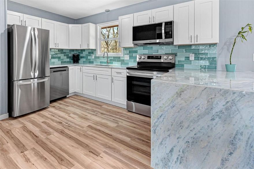 Freshly remodeled with high end finishes, a brand new roof and gutters, new appliances (including refrigerator), new windows, Shadow Storm hard marble countertops and waterfall, waterproof LVP flooring, and a gorgeous tile shower and tub surround. This home sits on a fairly level lot and is surrounded by mature trees. The front yard is nearly all rock so very low maintenance. As a bonus this home features a 680 SQFT heated and cooled basement with potential to be your dream workshop. The basement has several outlets and plumbing in place for a sink. The Flo-Ride trail is less than 60 seconds from your front door via bike. Enjoy some of the best biking and hiking in Bella Vista without ever hopping in a car! Property is agent owned. RD eligible.