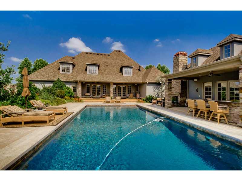 Sophisticated style w/ a stunning backyard oasis! Zebra wood cabinets, wolfe appliances, wine cellar, media room w/bar. Remodeled master bath, secluded patio off master, w/koi pond, hot tub, water fall into pool. Guest pool house w/ out door shower area!,Out door kitchen and fireplace. House has been repainted on the outside and NEW roof!!!
