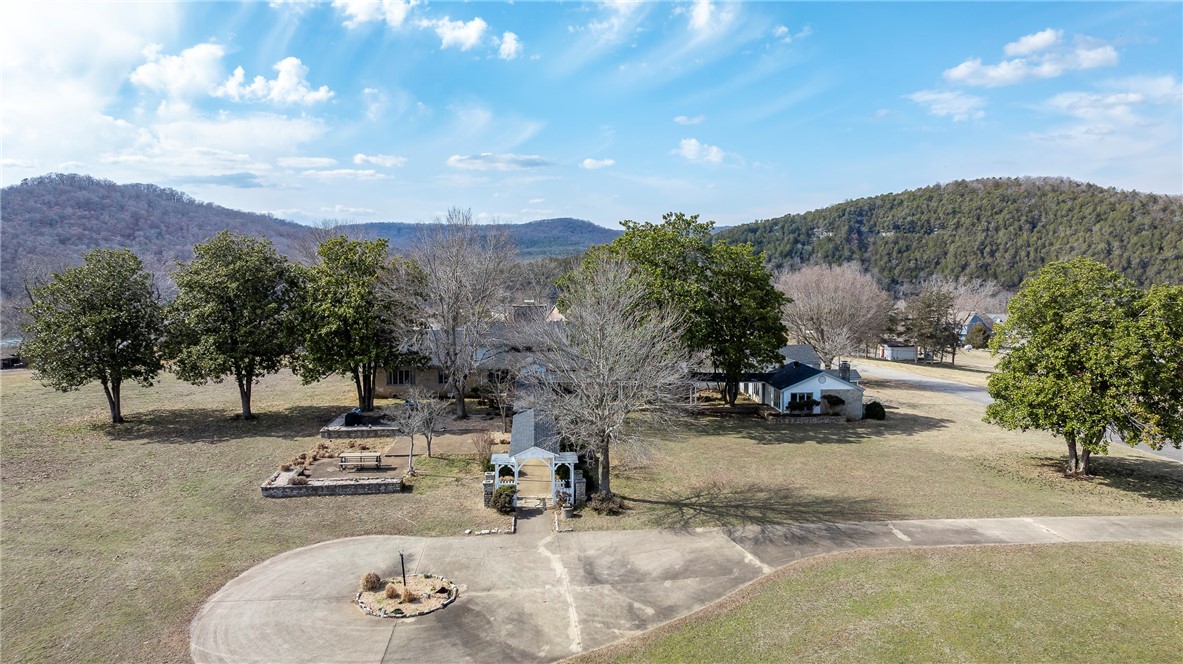 Nestled on 2.23 acres in beautiful Holiday Island, this 6,276 sq. ft. historic home offers a unique blend of character, space, and opportunity. Featuring 4 bedrooms and 3 baths, this property is perfect for a private estate, multi-generational living, or an investment venture. With stunning natural surroundings and access to lake and golf amenities, the lifestyle here is unmatched. Want even more space? An additional 10 acres is available for expansion. MLS# 1298550. Don’t miss this rare chance to own a piece of history with modern potential!