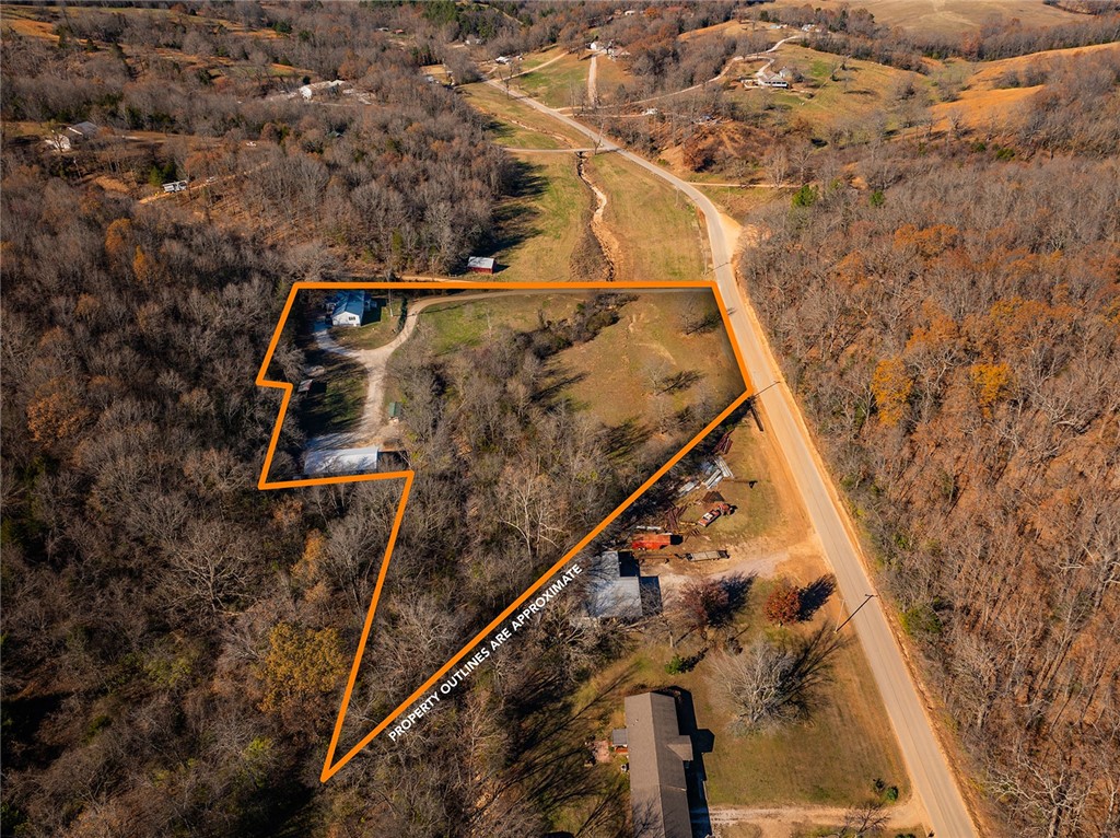 Discover your dream home with this thoughtfully upgraded 5-bedroom, 2-bathroom property, offering 2,300 +/- square feet of space on 4 +/- acre lot just outside Harrison, Arkansas. This move-in-ready gem is brimming with modern improvements designed to provide comfort, convenience, and endless possibilities. With 5 bedrooms and 2 bathrooms, this home is perfect for growing families or those who need extra space for guests or a home office. This home offers a huge master bedroom that serves as your retreat, a large family room perfect for entertaining or relaxing, and a beautifully tiled shower that adds a luxurious touch. There are newer water lines, gas lines, electric, and plumbing for peace of mind. More recent upgrades include a new septic system, enhanced insulation for improved energy efficiency, and durable and stylish vinyl plank flooring throughout. There is a new versatile 40'x60' shop with a small apartment, ideal for hosting guests, creating a rental opportunity, or establishing a home-based business.