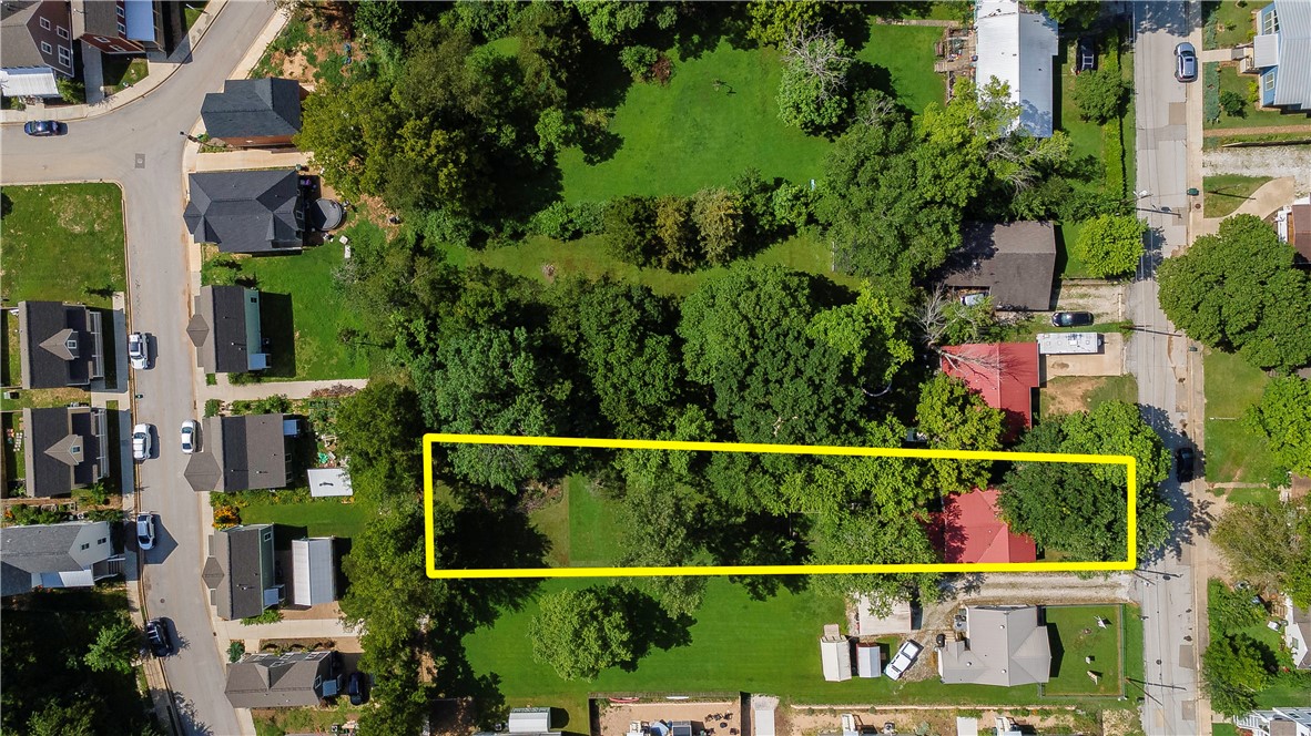 So many possibilities with this ideally located property! Zoned NC (Neighborhood Conservation) and situated within the Walker Park Neighborhood Master Plan, this lot offers outstanding potential just minutes from downtown Fayetteville, the University of Arkansas, Walker Park, and the Razorback Greenway. The property may potentially be split into two lots—each with the option for a single-family home and an accessory dwelling unit (ADU). Think guest house, rental unit, multigenerational suite, or home office—the possibilities are wide open. The existing structure is being sold as is, with the value primarily in the land. A great opportunity for builders, investors, or anyone looking to be part of a growing, vibrant area. Buyer to verify zoning and development potential with the City of Fayetteville. Adjacent property to the south is also available—see MLS 1315540 for details.