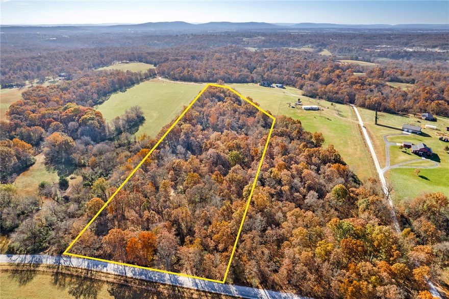 Located just west of Fayetteville on John Garrison Road, this 10.31± acre tract has recently been improved, making it an excellent opportunity for a custom homesite. The property is approximately 20 minutes from Fayetteville and is zoned for the Fayetteville School District, offering privacy with convenience.

The owners have invested significantly in the land, including dirt work that created a level, build-ready homesite near the back of the property. The upgraded, graveled access road now allows easy vehicle access to the homesite, with a newly installed culvert providing proper drainage and long-term durability.

Selective clearing along the front of the property removed underbrush while preserving mature hardwoods, creating an additional potential homesite. The tract features rolling terrain, mature timber, and over two acres of open pasture, offering multiple build options for a private estate.
