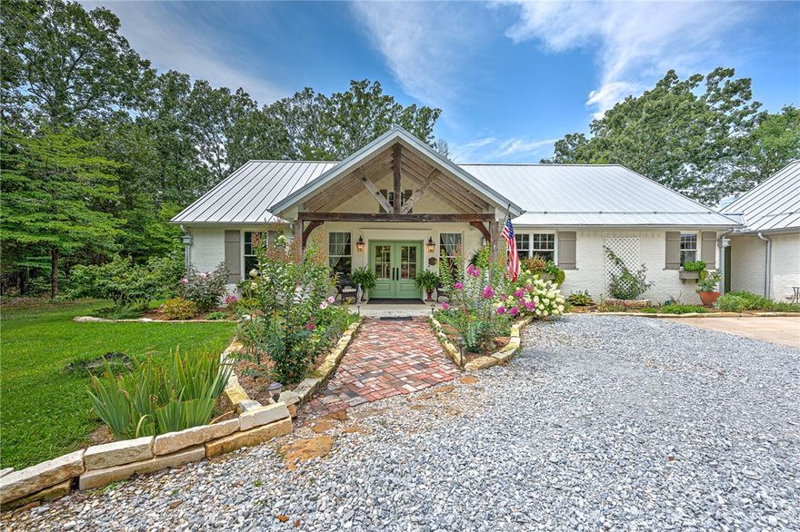 Discover your serene 21-acre French Country Oasis! Embrace the tranquil woods and lush gardens surrounding the 2196 sq ft main house, plus an additional separate guest suite (465ft) connected by a breezeway to the garage. Bask in the bright open floor plan, adorned with Egyptian sconces and antique corbels from a St Louis' bank. The great room's vaulted wood ceilings flow gracefully to the chef's kitchen, boasting quartz countertops and a delightful dining area with a walk-in pantry and coffee bar. The split floor plan houses 3 charming bedrooms. Entertain with ease on the welcoming front porch or the spacious vaulted rear screened-in porch with a fireplace, where you can relish the soothing water fountain sounds and the sight of hummingbirds. Washer/dryer, fountain, water purification/softener are all included. Enjoy your very own private shooting range and compost areas.Masons Creek on the property.Opportunities like this do not come along often! This 2018 custom-built gem by Wayne Foster is your dream come true!