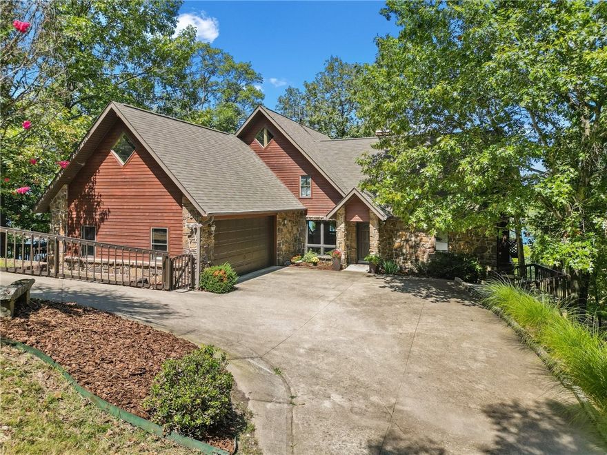 From the moment you approach the custom built home, the quality and relaxed grandeur is apparent. Entering this stunning Timber Frame Lakefront home, you instantly start enjoying unparalleled views of the lake, and the architectural details of this meticulously crafted home. Hickory wood floors, vaulted & beamed ceilings, stone wood burning fireplace, & floor to ceiling windows. Custom cherry kitchen cabinets, with tons of storage. When not on the lake you will experience multiple areas to relax & enjoy beautiful views & nature. Upstairs is a spacious loft & storage. Downstairs is the game room, access to the patio, 2 bedrooms & bathroom. The firepit is the ideal spot for stargazing, storytelling, & roasting marshmallows. The perfect setup for lake living with family and friends. The property includes a metal shop/storage building, PRIVATE 2 slip dock, 2 lifts, & 14x36 swim deck, a 720 sq. ft. guest house with loft bedroom, kitchenette & bathroom. Situated on a generous 15.98 acre peninsula with 1831' of lakefront.