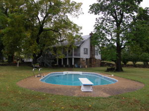 ROOM FOR EVERYONE, This 4 bedroom, 3 bath country charmer sits on almost 20 acres, fenced and cross fenced for the animals A Huge 2500 SQ FT of living space. and 2 kitchens, each level of the home has its own bath. Sit and listen to the birds with front and back porches, rear porch deck overlooking the in-ground pool. 24x24 garage, 24X32 shop,36X54 metal barn, Huge established trees.