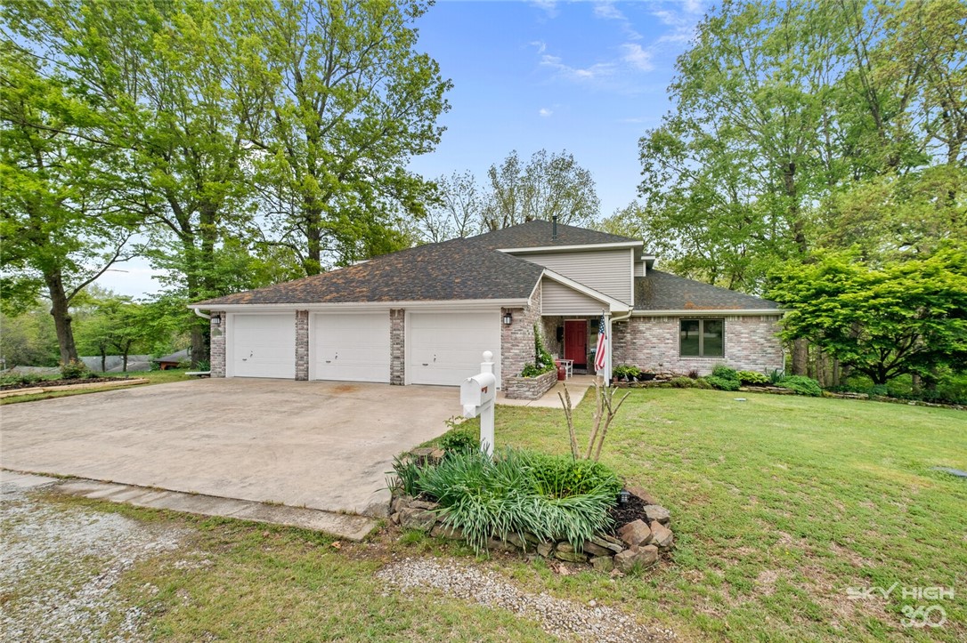 Lakefront 5Br-4Ba on almost 1 acre. Walk down to the water for easy access to canoe, kayak & fish! Energy efficient with 2x6 exterior walls, R-60 insulation in the ceiling, high efficiency furnace, 16 seer A/C (3 zone HVAC system), high efficiency windows and naturally shaded by mature trees!
Primary bedroom is on the main level with ensuite bath with double vanity, whirlpool tub, walk-in shower & walk-in closet. Spacious kitchen with solid surface countertops. Comfortable living room with gas insert fireplace. Dining area with soaring cathedral ceiling. 2 bedrooms, landing and full bath on 2nd level. Mostly finished walk-out basement with a bedroom, office, living space and tons of storage. Whole house attic fan. 3 car garage. All of this only 4.8 miles to Harps/Walmart, 2 miles to the elementary/middle schools & 3.3 miles to a boat ramp.