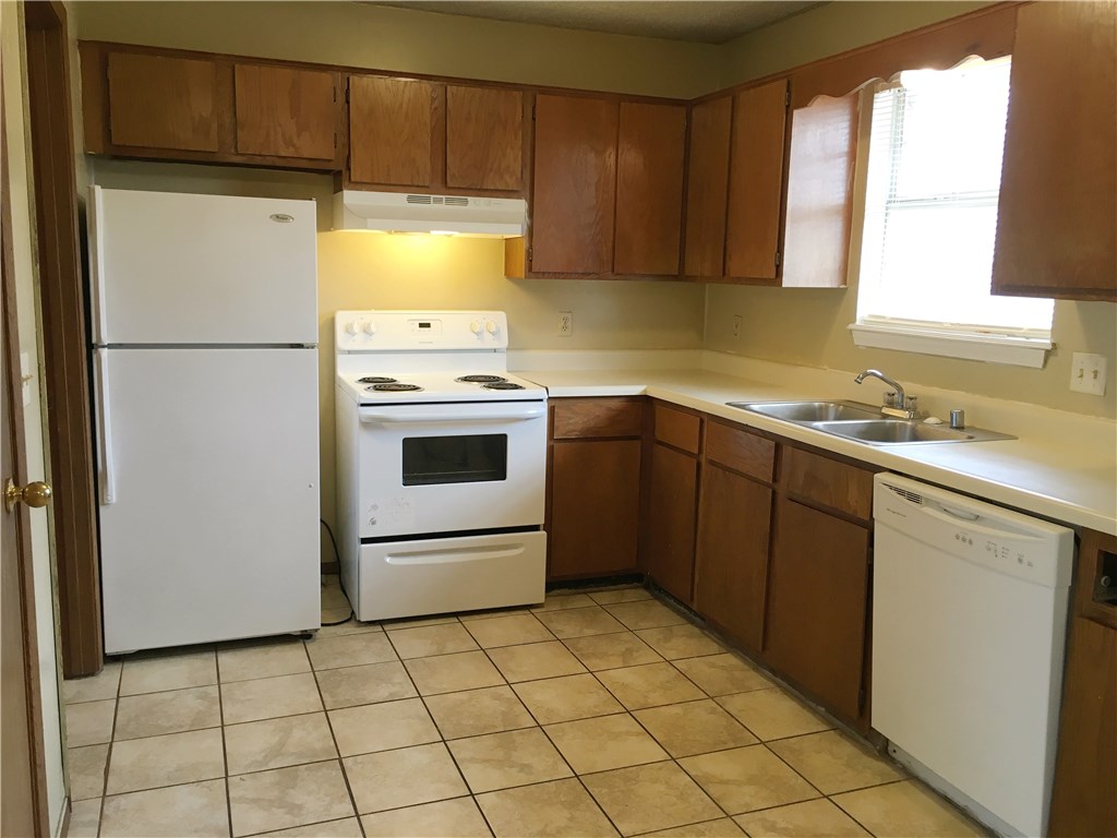 2 bedroom, 1 bath duplex with one car garage and fenced back yard. Kitchen overlooks eating area with refrigerator, stove, and dishwasher. Laundry room has washer/dryer hookups. Shower/tub combo in bathroom. Ceramic tile throughout unit. Tenant pays electric, gas, water/trash. Corner lot.