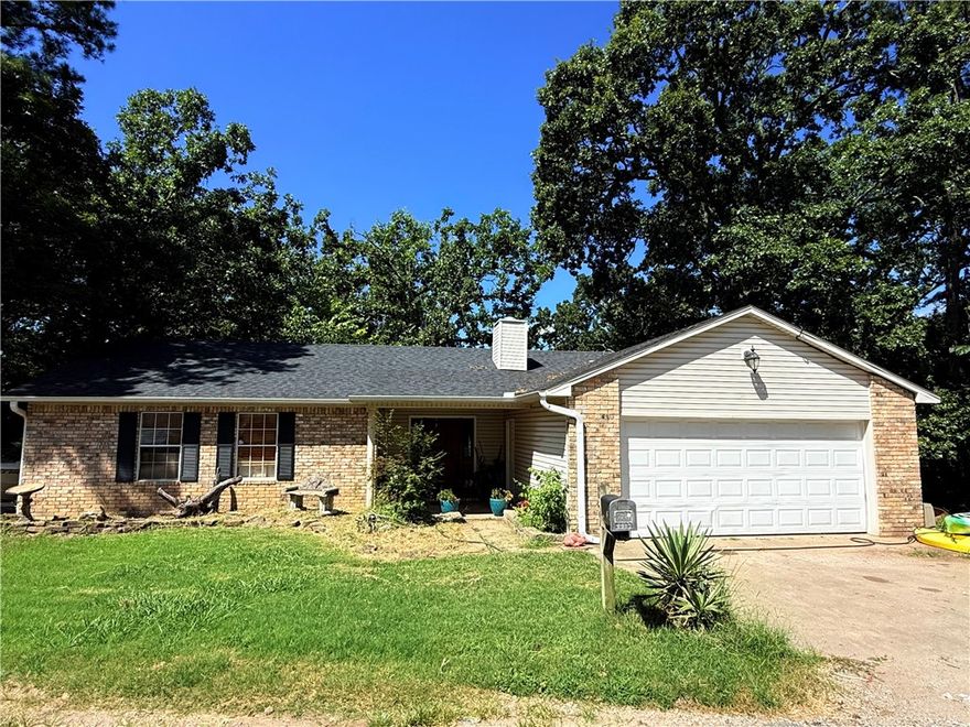 Opportunity knocks just 10 minutes from downtown Rogers! 8517 Spruce Drive sits on a peaceful wooded lot and offers endless potential for the right buyer. Roof was replaced in April 2025 as an added value! This property needs work, but with some vision and sweat equity, it could be transformed into a charming retreat or savvy investment. This home has seasonal Lake views in four rooms, a spacious covered deck, there is also a near nearby boat ramp off of Highway 12 and Prairie Creek Marina!