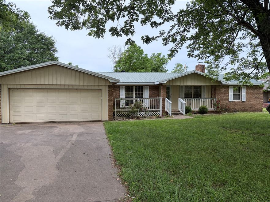 Spacious home in need of TLC & updating! 3 bedroom 2 bath with a bonus room. Newer metal roof, covered deck, fenced back yard, oversize 2 car garage, WB fireplace. Close to I-40 & I-49 access, restaurants, doctors, schools, churches, fire station. Being sold AS IS.