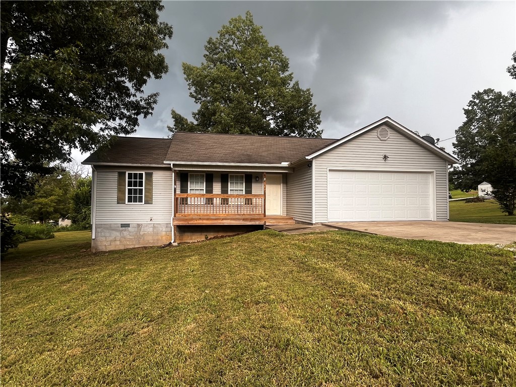 Take a look at this 3 bed, 1 and 1/2 bath home with a cathedral living room, huge yard, and a spacious back deck for any outdoor activities. It has Central heat and a/c, updated fixtures, and an oversized garage for all your needs! This home is located on a spacious lot just 2 miles from the school with a small gravel drive. It's got big shade trees and a country setting that could be just right for you!