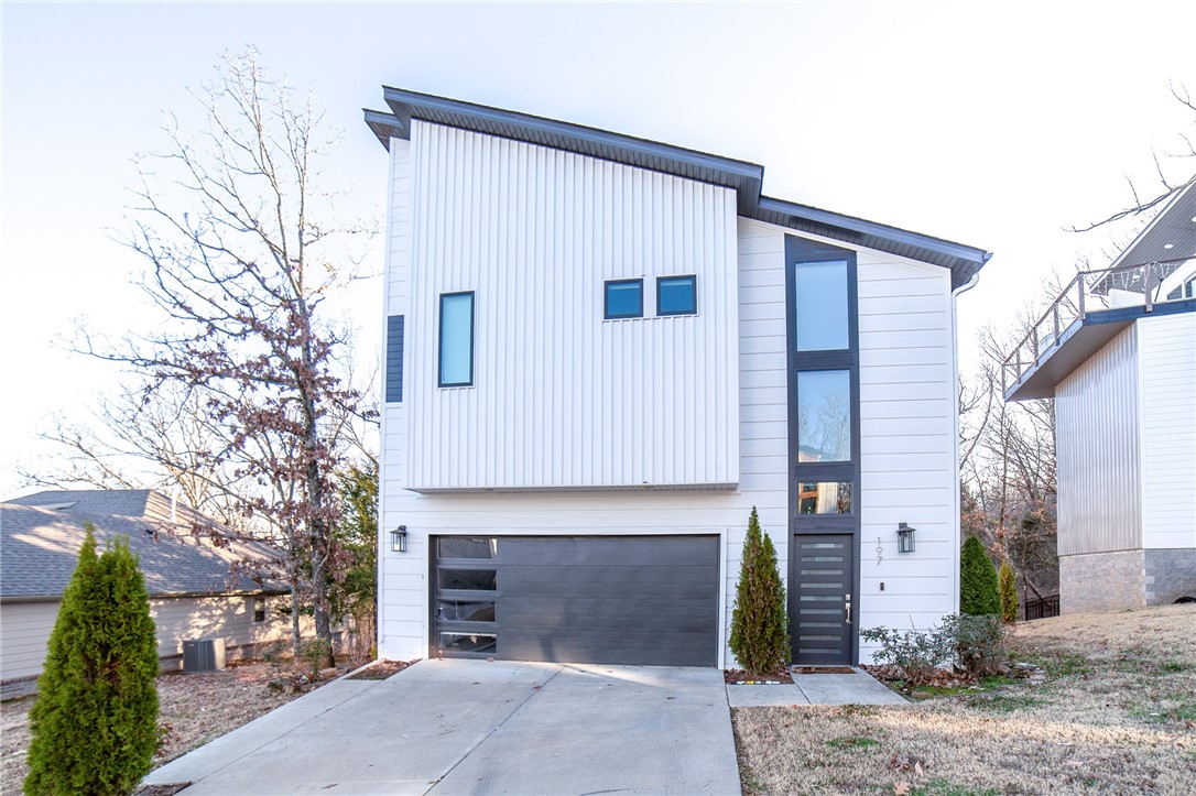 You do not want to miss this contemporary masterpiece. NWA real estate is truly an art to behold, and this one will not let you down. Located in the quaint Treetops subdivision and situated on arguably the nicest lot, sits this 1 owner Rouse Custom Homes built beauty. The split floor plan is perfect for guests with 2 beds, full bath and laundry downstairs. Upstairs you'll find the open living, eat-in dining and kitchen all adorned with hand scraped hardwood floors. Plus Sonos controlled sound system installed to wow your guests. Walk in closet and huge shower are truly a show stopper off the master bedroom, and don't miss the staircase to heaven with a bonus above the master. Ugrades include 1GB mesh wifi network - a $3k home network! Rejuvination custom light fixtures. Nest thermostat and Tesla charger both convey.
Natural light abound the entirety of the house, but the views can't be beat from the balcony overlooking both the Mt Sequoia trailhead and protected green space surrounding the property. Welcome home.