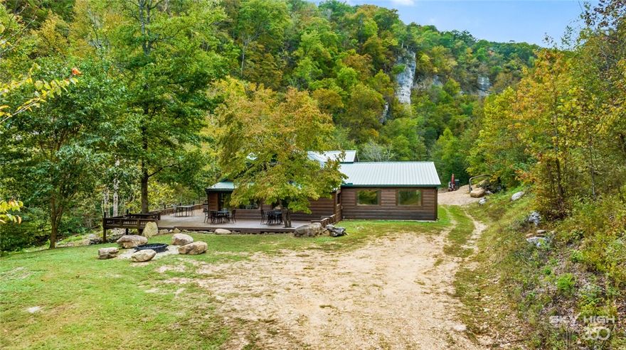 Surround yourself w/ soaring bluff views of the Ozark Mountains that anchor the Buffalo National River, & Edgeman Creek.Located in Historic Boxley Valley!With a seasonal wet weather creek flowing through the property, a waterfall, & a spring- early summer swimming hole right out your front door, this property checks all of the boxes for any outdoor enthusiast.This stunning log cabin has caves behind the property waiting for you to explore,  provides unmatched privacy & seclusion, and is still all within a short drive to the areas most iconic hiking trails such as Whittaker Point,The Goat Trail, Lost Valley, Ponca access to the Buffalo River, the Wilderness ATV park, &many historical sites such as the Boxley Baptist Church.This outdoor refuge has been updated & is surrounded by 20 acres of untouched nature for you to explore. The architectural timber beams on the interior are truly breath taking & one of a kind.With 6 bedrooms, this home can sleep up to 16 guests for all of your family gatherings & rental potential.