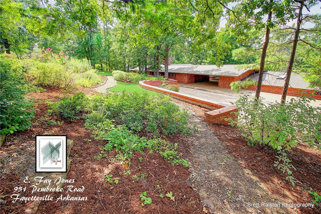 Fay Jones Home! A rare opportunity to own a strikingly beautiful home designed by the Master architect Fay Jones. Set within an award winning garden, cathedral ceiling and mammoth fireplace accentuate the geometric patterns on windows, door, cove lighting the many built in cabinets and bookshelves as well as the home’s connection to its natural environmental setting. One continual roof line is the signature of Mr. Jones along with natural lightning throughout this massive brick home.