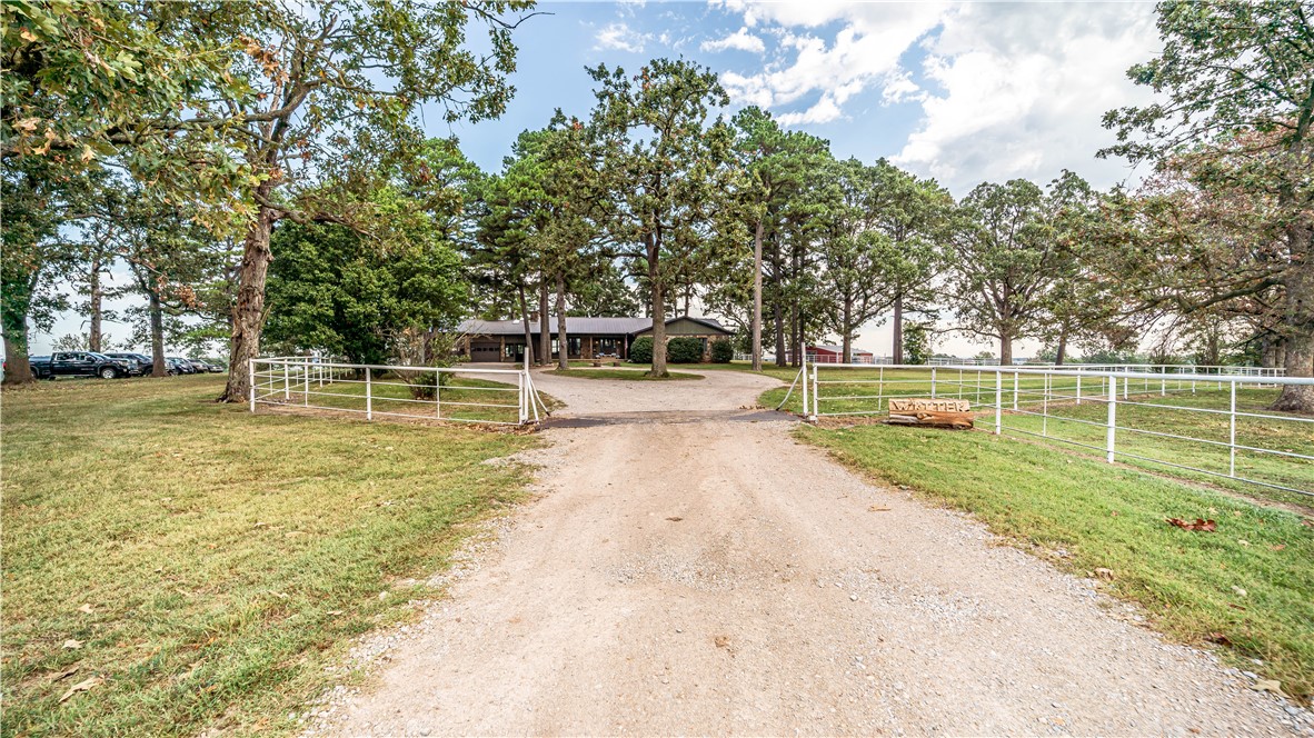 Turnkey Farm & Income Opportunity on 36 Acres! This 36-acre property offers a rare combination of a beautiful custom-built home and strong income potential. The 5-bedroom, 3-bath home includes an office, vaulted ceilings, wood and tile flooring, oak cabinets, a cozy wood stove, and a finished basement with additional bedrooms. The farm features three 32x380 chicken houses with new water and feed lines installed in 2025 and an existing premium contract, creating immediate income opportunities. Supporting infrastructure includes over 3,000 feet of pipe fencing, cross-fencing, and two water lines, making it highly efficient for livestock operations. Additional amenities include a 4-stall horse barn with large pens, a dog pen (all with water and power), and a large pond and views all around.