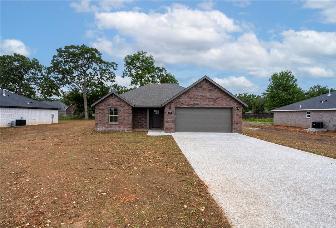 Buyers financing fell through so you have another chance to get this beautiful home! Gorgeous home built by a custom home builder with an eye for detail! 1525 sq ft with 3 bedroom and 2 baths. Lots of extras including full brick, granite, fireplace, walk in closets, soft close cabinets, spacious covered patio, on a hard to find extra large lot. Builder to sod front and sides and seed backyards. Perfect open floor in this adorable small town. The school is on the same street! Don't miss the opportunity to own this new home!