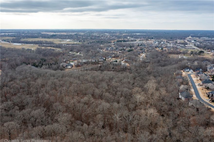 A once-in-a-lifetime opportunity to own land right in the heart of Bentonville. Close to Crystal Bridges, and Downtown Bentonville. Build your dream home or develop in a beautiful one-of-a-kind Subdivision. The sky is the limit with the opportunities this land offers. This acreage is in East Ridge which is a phase of Woods Creek and is guided under its covenants. The owner pays a POA fee of 400.00 a year. Covenants have and will be available upon request. City approval is needed on any plans.