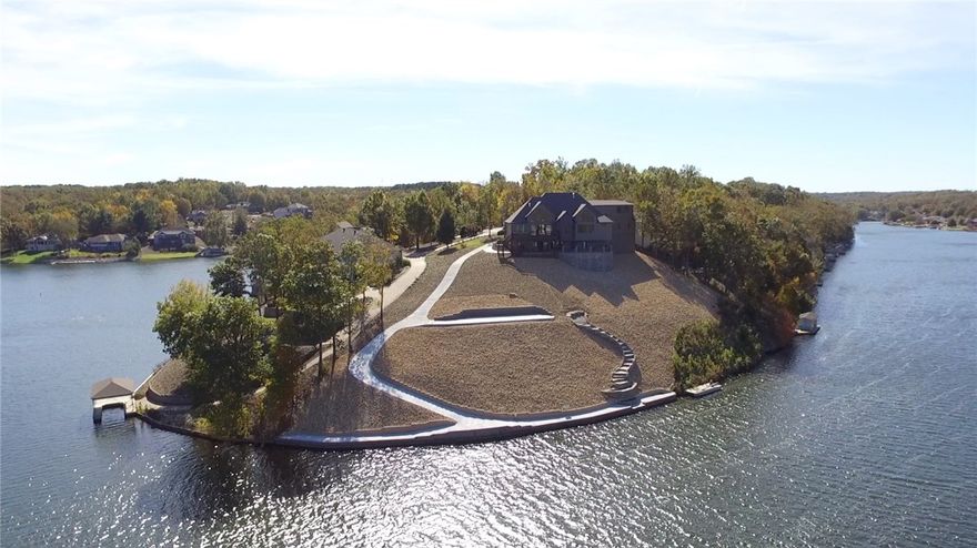 Experience the most breathtaking views from this brand new lakefront home. Built by OAK Homes, this incredible estate sits on over an acre above beautiful Lake Loch Lomond. Enjoy boating, fishing, skiing or take a quiet cruise over to the marina where you can dine at Lakepoint Restaurant. This home captures true lake living at its best. The main living room boast floor to ceiling windows & a 20 foot stack stone fireplace. The gourmet kitchen features top of the line appliances package and walk-in pantry.