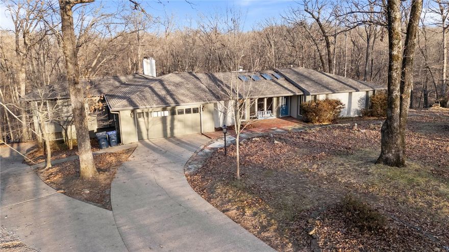 Tucked on a wooded 2+ acre setting just minutes from Downtown Rogers & Lake Atalanta, this one-of-a-kind retreat blends luxury amenities with character & story rarely found in today’s market. The expansive home unfolds through multiple living spaces including a primary living room, vaulted family room, flex space, sun nook, & game room. There's space & privacy for the whole family with 2 master suites, a built-in twin guest bedroom, and 4th bedroom with en suite bath. The kitchen anchors the home with a 48" 8-burner gas range with double oven, 5' SubZero fridge/freezer, abundant cabinetry, pantry storage, & wet bar. The raised deck overlooks the pool, stone patio, fire pit, & mature backyard trees. Walking through this property is an experience unto itself as you discover its built-in treasures like the stained glass details in the master and kitchen or the salvaged slate chalkboard floors in the basement. This home’s story has evolved over decades & is waiting for your next chapter to be written within its walls.