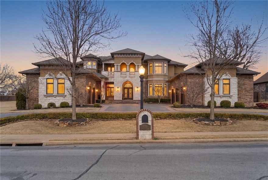 Located in the prestigious gated community of St. Valery Downs, this exceptional custom estate offers privacy, security, and unbeatable convenience—centrally positioned in the heart of Northwest Arkansas. This two-story residence blends luxury and functionality with high-end upgrades and built-ins throughout. Featuring new roof and windows (2025) and situated on 1.1 acres, the home includes a FEMA-compliant tornado safe room on the main level. Enjoy an expansive open-concept living, kitchen, and breakfast area anchored by a statement fireplace, plus a dedicated gym, private office and two laundry rooms. The gourmet kitchen boasts a built-in range, double ovens, steam oven, microwave, ice maker, refrigerator, and espresso machine. Enjoy resort-style outdoor living with a heated saltwater pool, outdoor kitchen, fire pit and multiple patios to complete this Bentonville oasis.