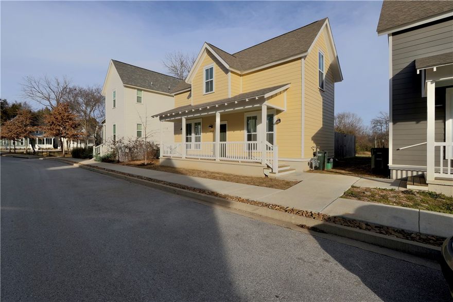 This charming two-bedroom, one-and-a-half-bathroom Modern Farmhouse welcomes you with its cheerful butter-yellow lap siding, crisp white trim, and a deep, full-width front porch. Furniture and appliances can convey with acceptable offer! Inviting open-concept floor plan characterized by light-filled spaces and warm wood-look flooring. The kitchen boasts efficiency and style, showcasing speckled granite countertops, a large stainless steel undermount sink, and white Shaker-style cabinetry with sleek black hardware. It's fully equipped with stainless steel appliances and illuminated by industrial-inspired pendant lighting. The living area is bright and airy, anchored by a neutral color palette and large windows with classic blinds. Practical features include dedicated laundry room & convenient powder room with classic pedestal sink tucked under the staircase. This home blends traditional rural charm with a clean, contemporary look. The backyard has a six foot fence, plenty of green space, and a raised bed garden!