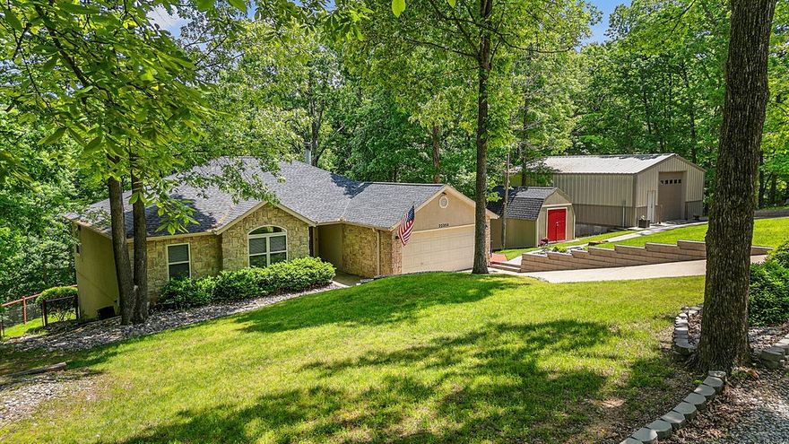 Seller offering up to 1% in closing costs paid!!! Don't miss this lake property - Tucked away on a private road is a 2,780 sqft home with 4 bedrooms, 3 baths, a community 12x28 boat slip, large shop & a seasonal lake view! Located on 1.64 acres, the property also features a wood-burning fireplace that can warm the entire home The eat-in kitchen features granite countertops, stainless steel appliances, freshly stripped & re-stained cabinets, & new hardware. The spacious primary suite includes a luxurious bathroom with a large walk-in shower & walk-in closet. Downstairs, you'll find a finished basement with a 2nd living area, bedroom & a bonus room with a wet bar, ideal for entertaining. Step outside to enjoy two expansive decks—1 upstairs & 1 downstairs. The downstairs deck includes a hot tub/firepit. 30x35 workshop with 12-ft garage door & built-in workbench provides excellent space for hobbies. 12x16 shed adds even more storage. Both house & shed -new roofs-2023. Added permanent lights on exterior feature.