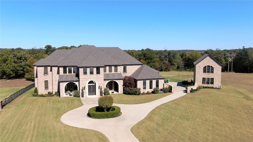 Luxury, Peaceful, living. And the best keep secret in beautiful gated Churchill Hill Downs Subdivision. Just minutes from Interstate I- 49. Stunning grand entry leading to Curved staircase and cathedral ceilings. An entertainer's dream offering formal dining room. Gourmet Kitchen 2 large islands, full size side by side refrigerator/ freezer and plenty of counter space. True butlers' panty with 2nd refrigerator, dishwasher and Ice maker. 2 Designer master suites one on each level with fireplaces, wet bar, his and her closets, including private balconies to sit and enjoy your 2.68-acre estate. Library/ office area, game room and media room. 6 bedrooms, 3 on each level. 4 car garages. And an 840 SQ Ft Guest house that could be used as a private home office space or business. 4 covered patio's and large stone patio all ready for your enjoyment. Call today for your personal showing.