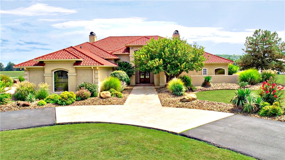Beautiful four bed, three and a half bath, old world mediteranean- style estate in East Springdale with shop/barn that has one full bathroom. One level home with acreage plus office, sunroom, three car garage and two living areas. Barn is over 1700 square feet and includes an additional full bathroom, rv hook up, covered rv parking, two horse stalls, tact room/hay storage, newly added covered front porch with cedar beam accents, additional frost free water taps for animal life and plenty of room to grow. 2x2 Travertine flooring thoughout, limestone pillars and fireplace, mahogany and antique doors, extensive crown molding, custom wood features, two gas fireplaces including a KIVA adobe surround in the iving area. Cedar lined closet next to office, ample storage, wide hallways, patures are fenced with iron and cable fencing, there is a cattleguard at entrace to the property, entrance off monitor is shared.
