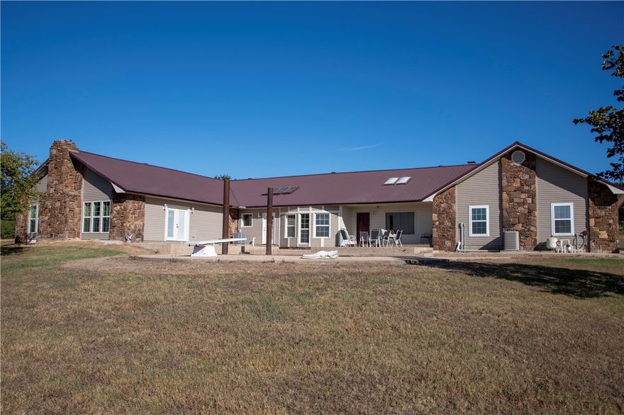 Looking for space, acreage and a shop? Well, this updated country home situated on 22 acres is it. Nestled on a slight hill sits a beautiful 3811 square foot home w/2 master bedrooms,4 baths, 2 living areas, a pool & barn. House is designed to offer flexibility & functionality w/plenty of open space, multiple access points, views of the countryside & outdoor entertaining area with inground pool.  On cold winter nights snuggle up in front of the massive fireplace or just mediating beside the indoor water feature. If you are interested in the practical aspects of the home it features a large dining space and oversized laundry room with lots of cabinet space. There is tons of natural light, vaulted ceilings throughout w/ skylights. The large barn has electricity, easy water access, working pens & metal fencing outlining the boundaries. All this is sitting minutes from the Missouri line & still just a short drive from everything NWA offers. Come look & love it. Owner says bring any offer and let's negotiate.