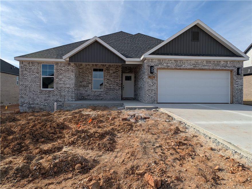 Welcome to this stunning new-construction home in the sought-after Spring Creek Subdivision of situated perfectly between Bentonville and Fayetteville. From the moment you arrive, the beautifully detailed brick exterior and inviting covered porch set the tone for the quality within. Step inside to discover a spacious interior filled with natural light where the vaulted living room is anchored by beautiful built-ins and an inviting gas log fireplace.  The gorgeous living opens to the true heart of the home--the immaculate chef’s kitchen, complete with sleek quartz countertops, custom cabinetry, a walk-in pantry, and a large island perfect for gathering. But the true highlight of this home is the show-stopping primary suite featuring a rich wood-accent tray ceiling and generous windows.  Every detail—from the upscale finishes to the thoughtfully designed layout—creates a space that feels both luxurious and livable. Find your style, comfort, and convenience in one of Springdale’s most desirable neighborhoods!