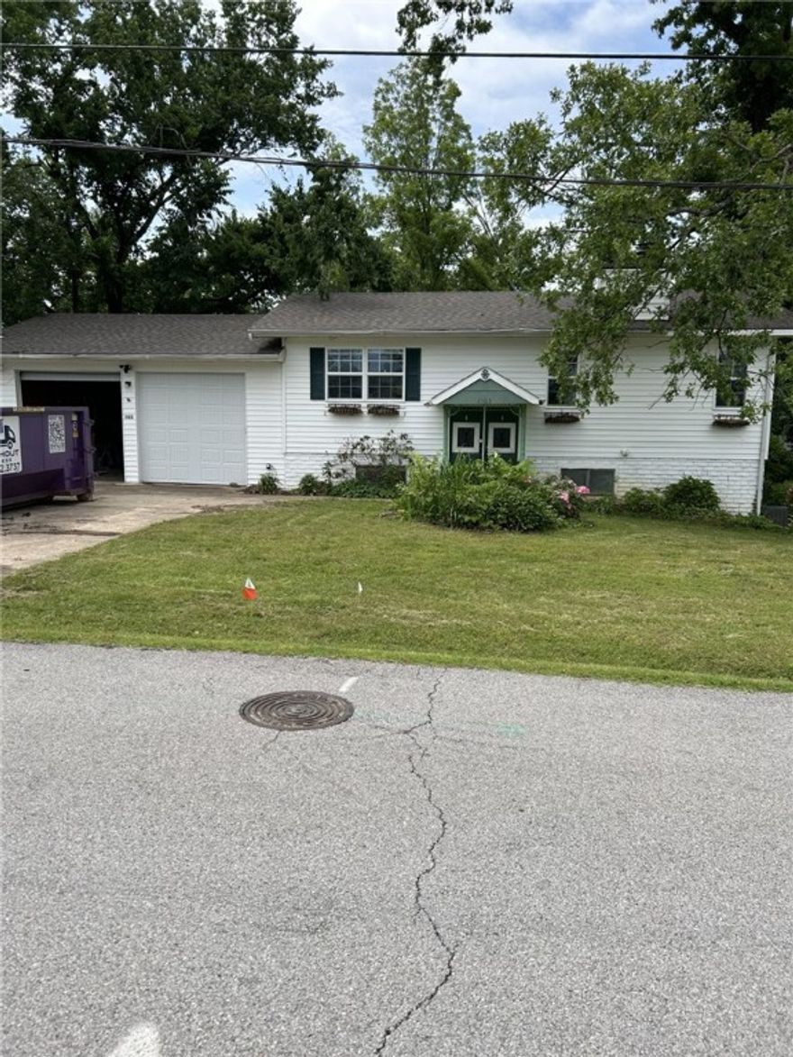 Multi Level home in Bentonville with tons of potential.  Close to downtown and all that Bentonville has to offer. Updates include new windows downstairs, gutters, freshly painted interior, and new carpet in family room.