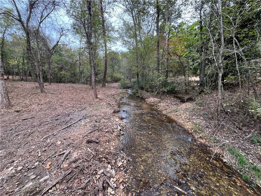 Prime Investment Opportunity – Nearly 20 Acres in Highfill/Gentry, AR! Located less than half a mile from the rapidly growing town of Highfill and just 3 miles from Northwest Arkansas National Airport, this property offers outstanding potential for development, income, pasture, timber, or long-term investment. A natural spring and creek run through the land year-round, electric is already on-site, and water is available at the street—making this a rare find in a high-growth area. Approximately a 1600 sqft Shop on the property with no value given.