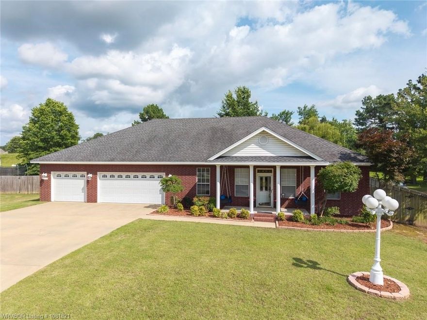 This beautifully maintained 4-bedroom, 3-bathroom home offers generous space and thoughtful design throughout. With defined rooms rather than an open layout, you’ll enjoy a formal dining room (or parlor), cozy sitting room, eat-in kitchen, living room, and bright sunroom—providing plenty of space for relaxing or entertaining. The 3-car garage includes a permanent staircase to a large bonus room in the attic (not included in square footage) plus ample floored storage. Sitting on over half an acre with mature trees, the property features a peaceful backyard ideal for watching sunrises and wildlife from the covered porch or gazebo. High ceilings, crown molding, and elegant chandeliers add timeless character, while the covered front porch with two swings offers another quiet place to unwind. This total electric home is energy-efficient, with solar panels paid off at closing and a current electric bill of only $33. Conveniently located near schools and the interstate, this move-in-ready home is a special find.