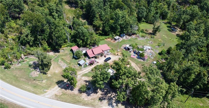 Own a beautiful 5 acres only 15 minutes from Beaver Lake and 30 minutes to Eureka Springs and 5 min from War Eagle. Plenty of room to build your dream home and be surrounded by nature.  Septic, Water and Electricity all on site.  Home and buildings on property hold no value, value in land.
