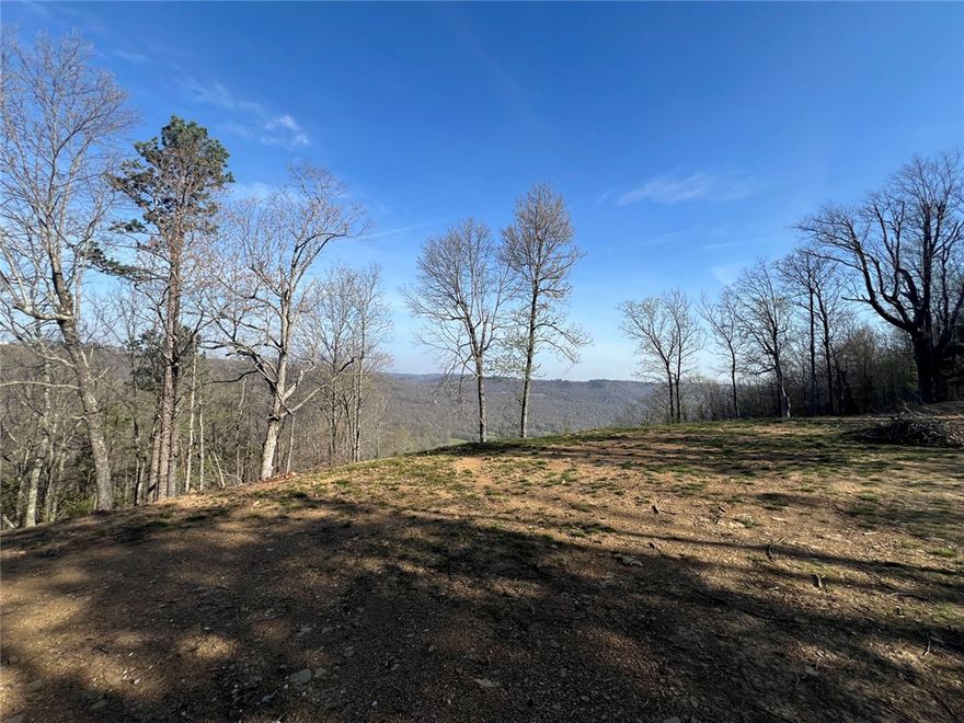 This 5-acre tract offers a rare combination of privacy, scenery, and convenience in the heart of the Ozarks. Tucked away on a quiet dead-end road, the property provides a peaceful setting with spectacular Ozark mountain views, while still being just a short drive from pavement and the amenities of Jasper.

The land is ideally suited for a home or retreat, with a gently rolling landscape that takes full advantage of the surrounding mountain views. Located near established hiking trails and the Buffalo National River, this property puts some of the area’s most sought-after outdoor recreation right at your fingertips.

Underground utilities are available, preserving the natural beauty of the setting and simplifying the building process. Whether you’re looking to build a full-time residence or a weekend getaway, this tract offers a strong balance of seclusion, accessibility, and scenic appeal.