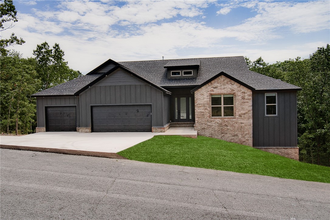 New construction on a large .47 acre wooded lot with breathtaking views! 3 car garage! Upon entering, you will be greeted with a large open kitchen, living area, and sitting room with tons of natural light and built-ins. The kitchen features a spacious pantry, oversized island, gas range, and plenty of storage space. The primary suite includes large windows, a freestanding soaking tub, walk-in tile shower, and a huge walk-in closet. Mud room features custom lockers. No carpet. Equipped with blinds and gutters. With Lake Loch Lomond, Highlands Golf Course, and easy access to I-49; this home combines serene living with the convenience of nearby amenities. Don't miss this opportunity to make this exceptional property your new home!